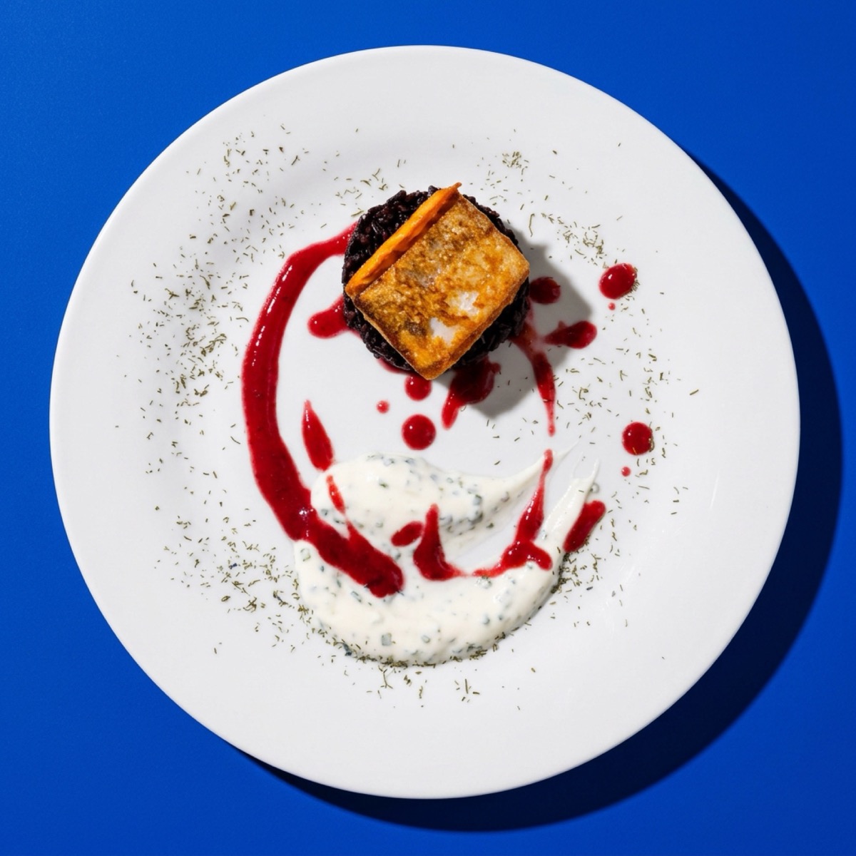 Pastry with raspberry coulis and cream